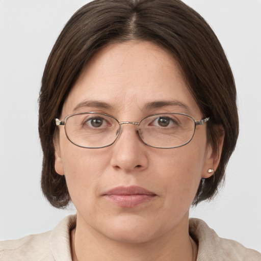 Joyful white adult female with medium  brown hair and grey eyes