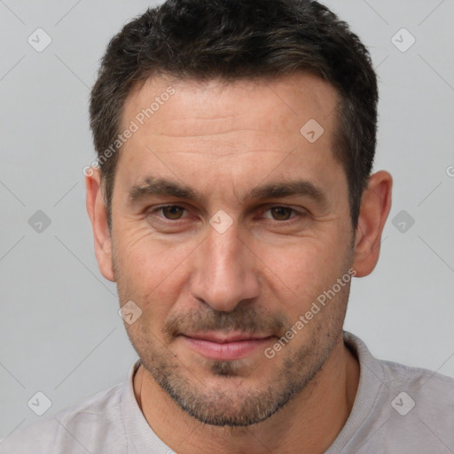 Joyful white adult male with short  brown hair and brown eyes