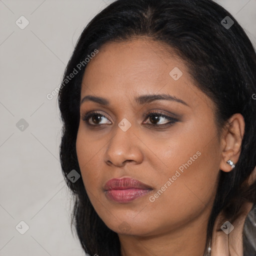 Joyful black young-adult female with long  black hair and brown eyes