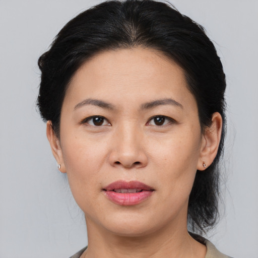 Joyful asian adult female with medium  black hair and brown eyes