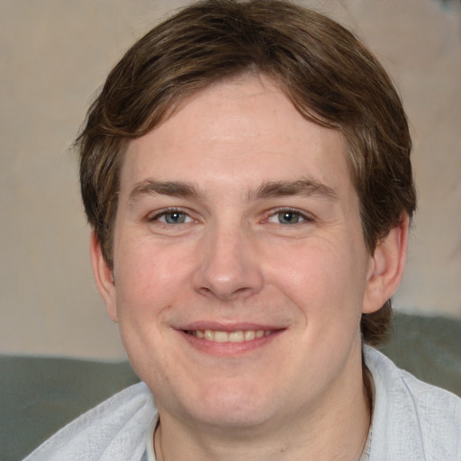 Joyful white adult male with short  brown hair and grey eyes