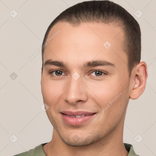 Joyful white young-adult male with short  brown hair and brown eyes