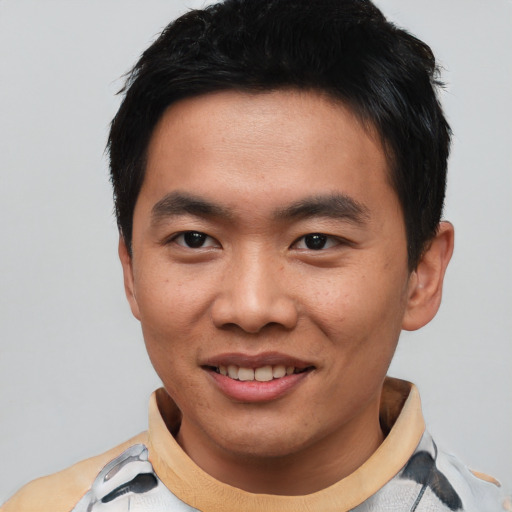 Joyful asian young-adult male with short  black hair and brown eyes