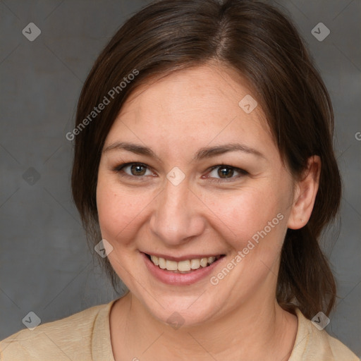 Joyful white adult female with medium  brown hair and brown eyes