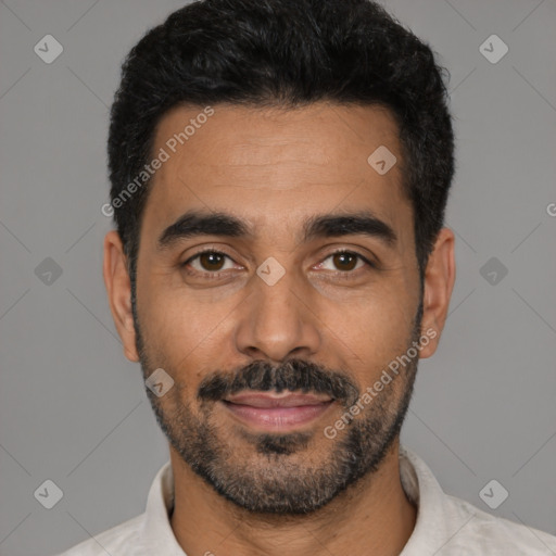 Joyful latino young-adult male with short  black hair and brown eyes