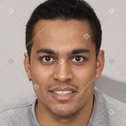 Joyful black young-adult male with short  brown hair and brown eyes