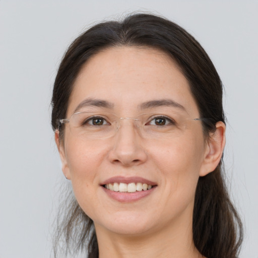 Joyful white adult female with long  brown hair and brown eyes