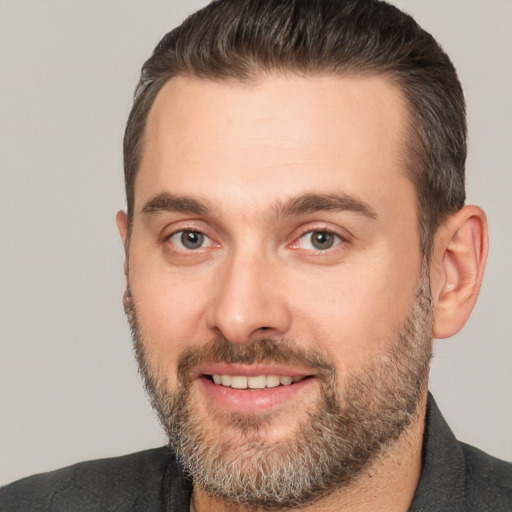 Joyful white adult male with short  brown hair and brown eyes