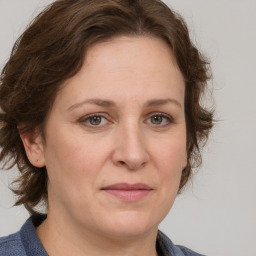 Joyful white adult female with medium  brown hair and grey eyes