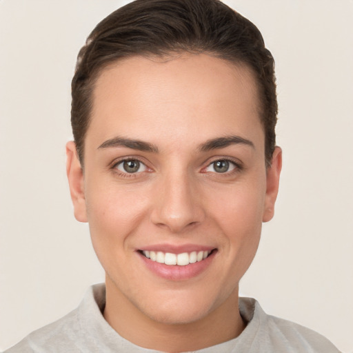 Joyful white young-adult female with short  brown hair and brown eyes