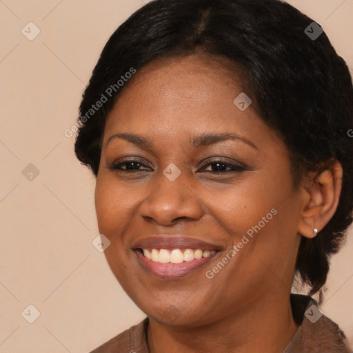 Joyful black adult female with medium  brown hair and brown eyes