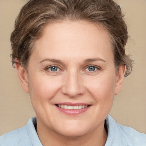 Joyful white adult female with short  brown hair and grey eyes