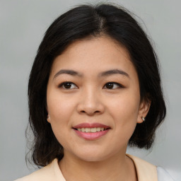 Joyful asian young-adult female with medium  brown hair and brown eyes