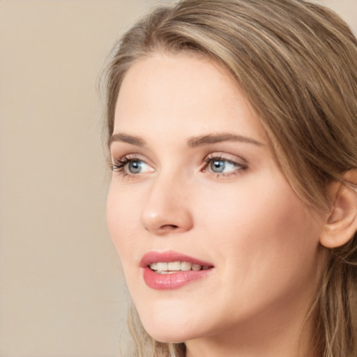 Joyful white young-adult female with long  brown hair and blue eyes