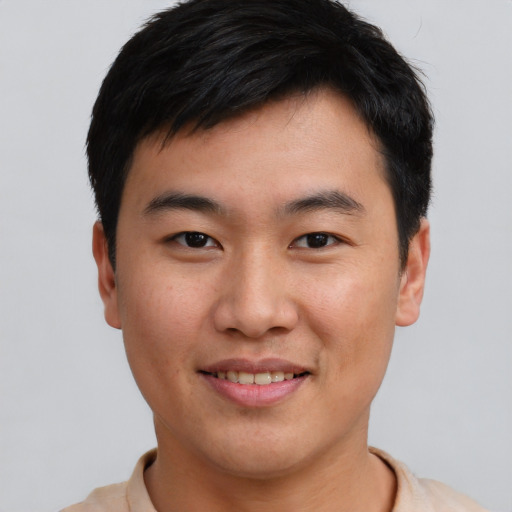 Joyful asian young-adult male with short  brown hair and brown eyes