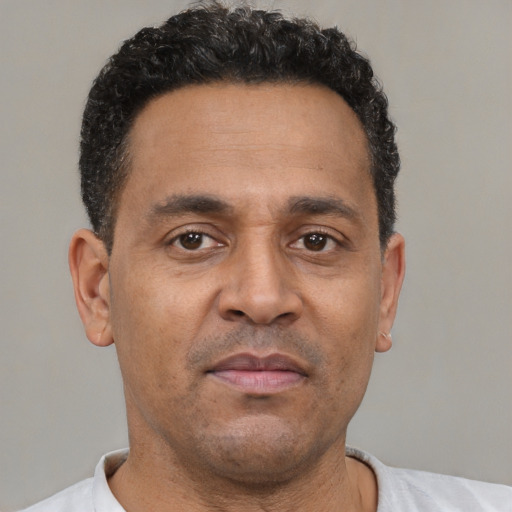 Neutral latino adult male with short  brown hair and brown eyes