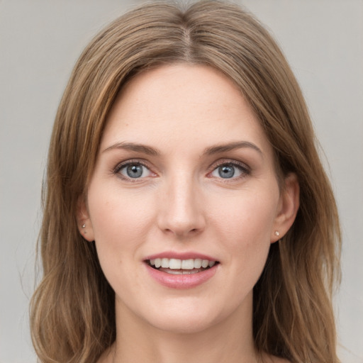 Joyful white young-adult female with medium  brown hair and grey eyes