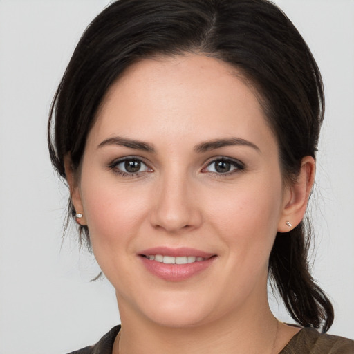 Joyful white young-adult female with medium  brown hair and brown eyes