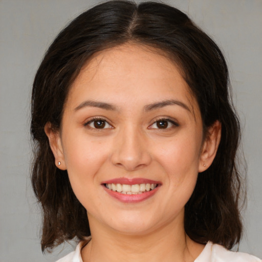 Joyful white young-adult female with medium  brown hair and brown eyes