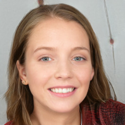 Joyful white young-adult female with long  brown hair and blue eyes