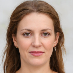 Joyful white young-adult female with medium  brown hair and green eyes