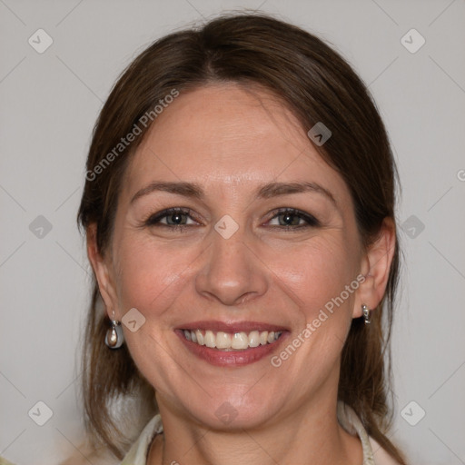 Joyful white adult female with medium  brown hair and grey eyes