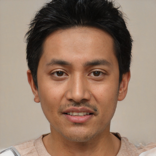 Joyful white young-adult male with short  black hair and brown eyes