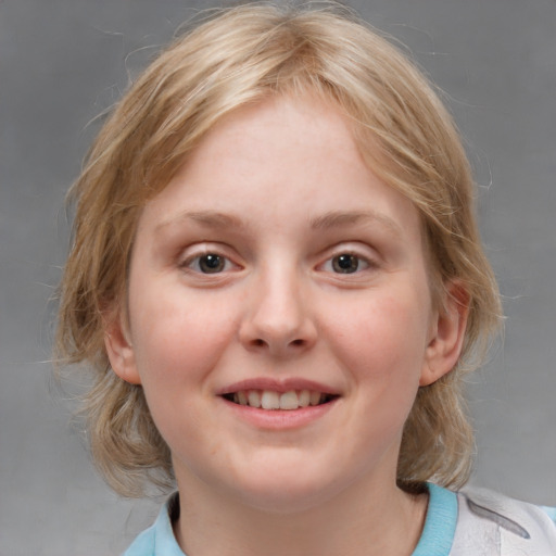 Joyful white child female with medium  brown hair and blue eyes