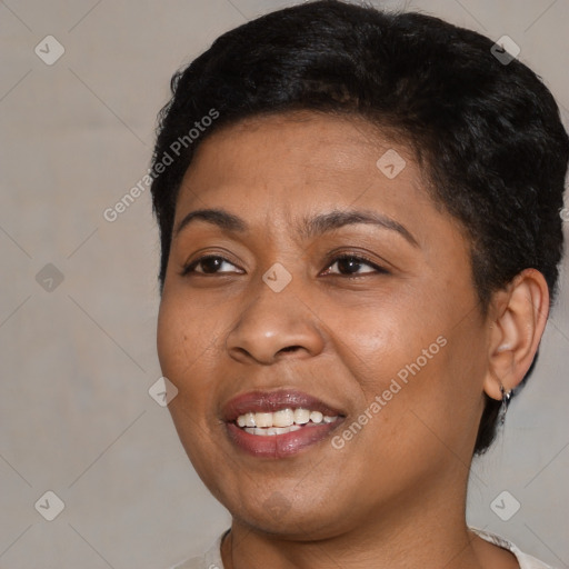 Joyful black young-adult female with short  black hair and brown eyes