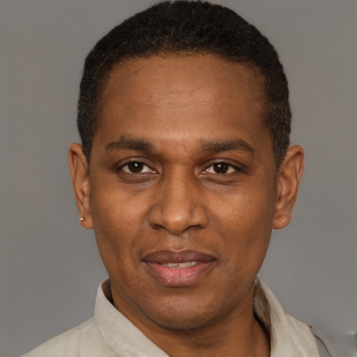 Joyful latino adult male with short  brown hair and brown eyes