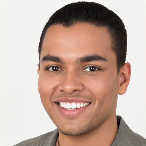 Joyful latino young-adult male with short  black hair and brown eyes