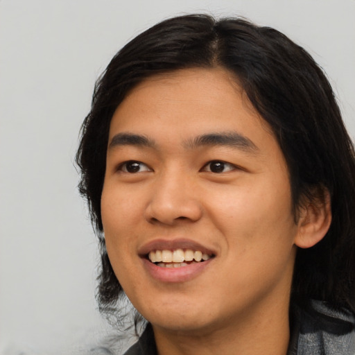 Joyful asian young-adult male with medium  black hair and brown eyes