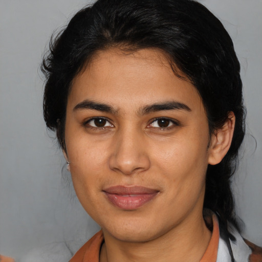 Joyful latino young-adult female with medium  brown hair and brown eyes