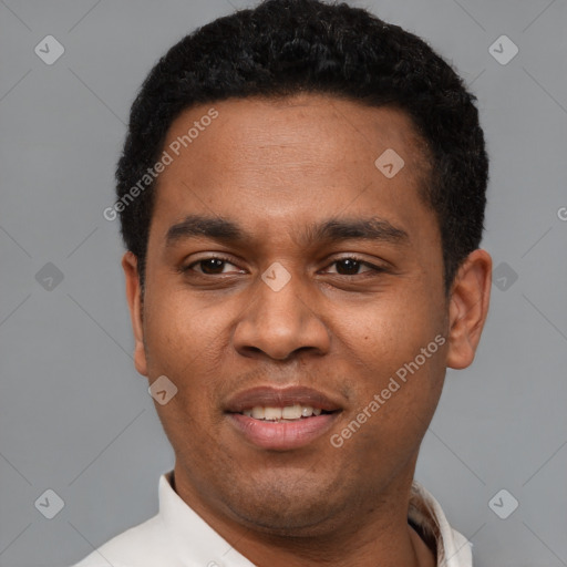 Joyful latino young-adult male with short  black hair and brown eyes
