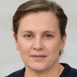 Joyful white adult female with medium  brown hair and grey eyes