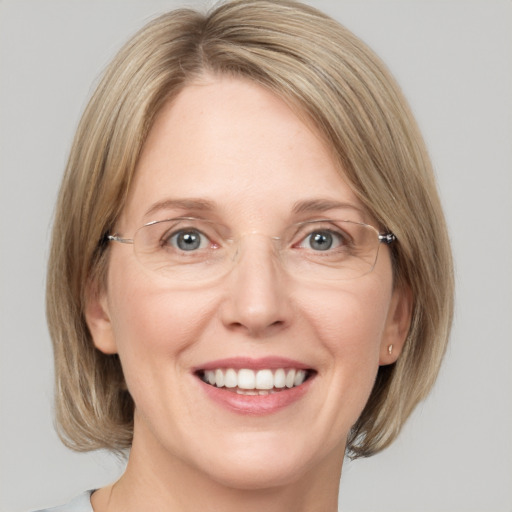 Joyful white adult female with medium  brown hair and grey eyes