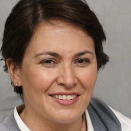 Joyful white adult female with medium  brown hair and brown eyes