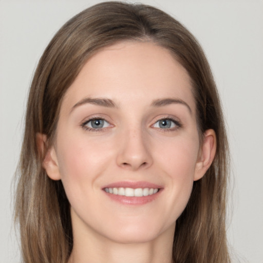 Joyful white young-adult female with long  brown hair and grey eyes