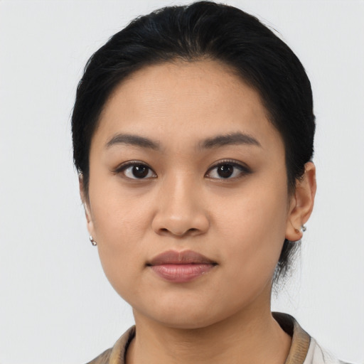Joyful asian young-adult female with short  black hair and brown eyes