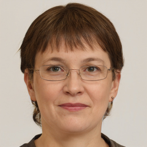 Joyful white adult female with short  brown hair and grey eyes