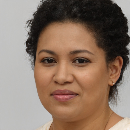 Joyful latino young-adult female with short  brown hair and brown eyes
