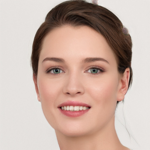 Joyful white young-adult female with medium  brown hair and grey eyes