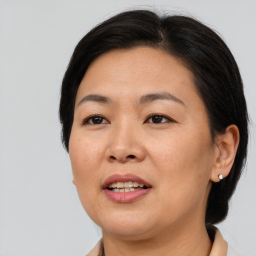 Joyful asian adult female with medium  brown hair and brown eyes