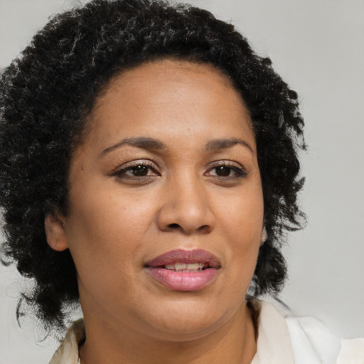 Joyful black adult female with medium  brown hair and brown eyes