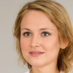 Joyful white young-adult female with medium  brown hair and blue eyes