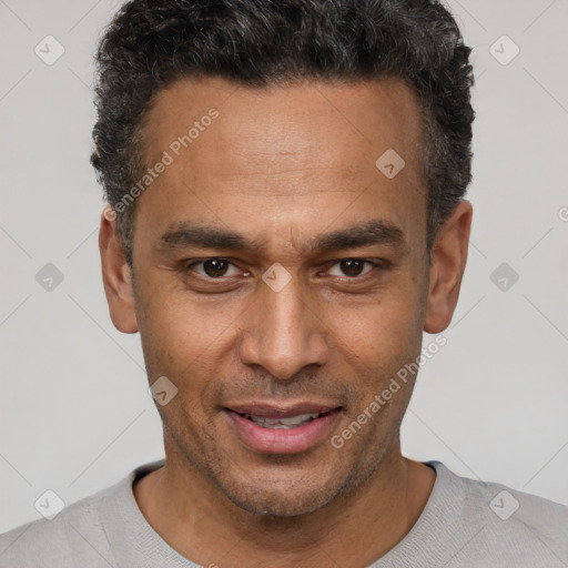 Joyful latino adult male with short  brown hair and brown eyes
