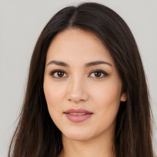 Joyful asian young-adult female with long  brown hair and brown eyes