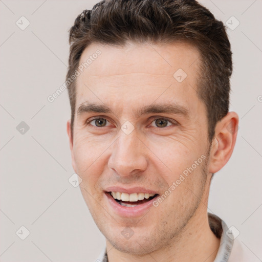 Joyful white adult male with short  brown hair and brown eyes