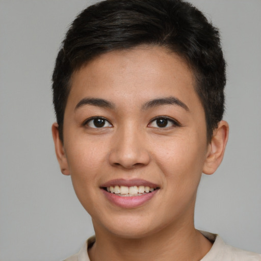 Joyful asian young-adult female with short  brown hair and brown eyes