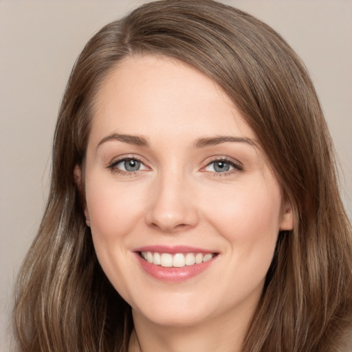 Joyful white young-adult female with long  brown hair and grey eyes